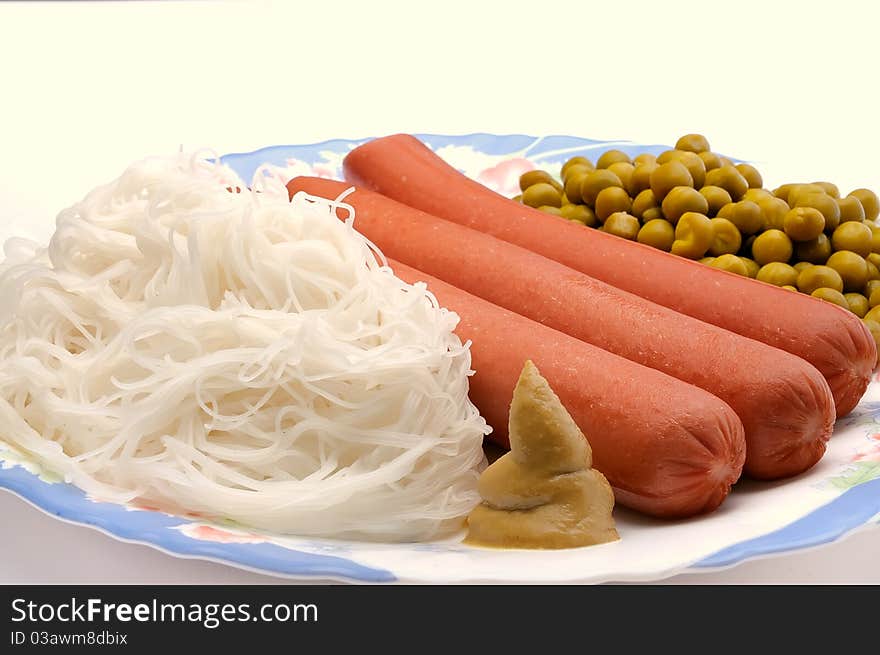 Dish with sausage, noodles and green peas. Dish with sausage, noodles and green peas