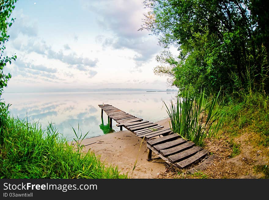 The wooden bridge on the bank of lake