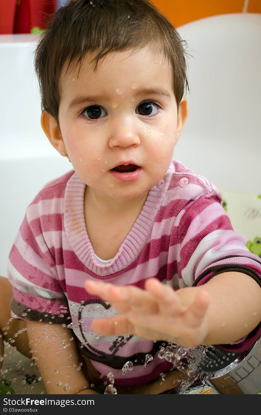 Little girl wanting to take a bath with cloths on