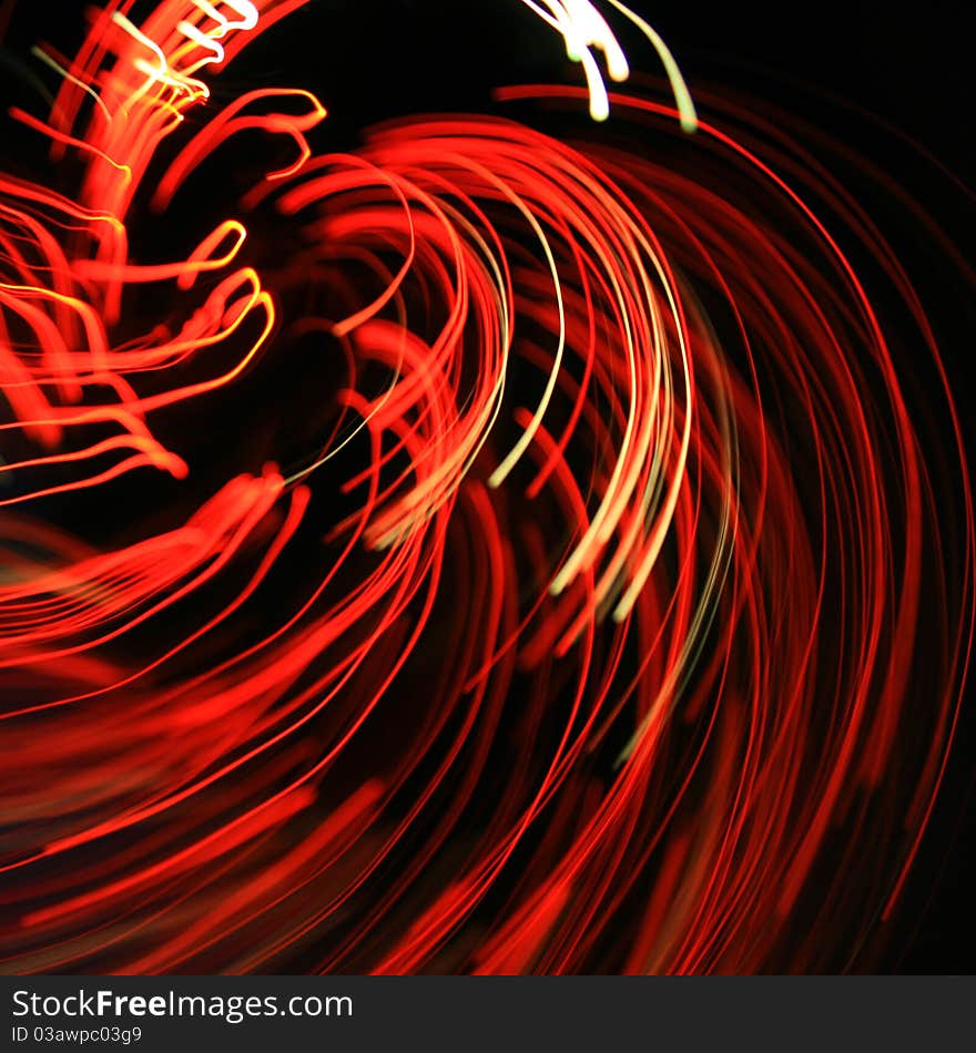 Glowing red twirly lines on black background. Glowing red twirly lines on black background