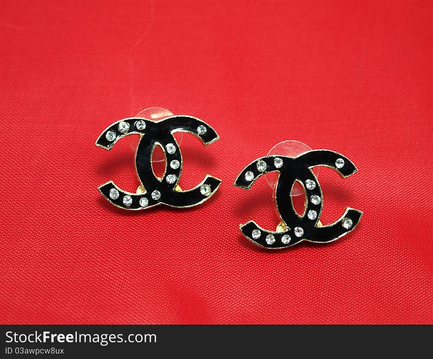 Black Earrings with isolated on red