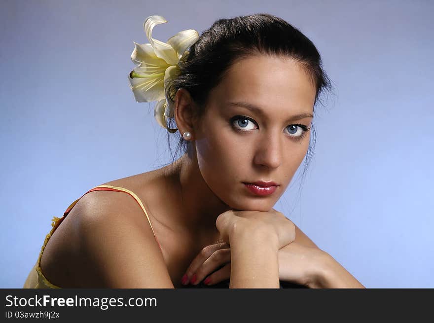 The beautiful girl with a lily in hair