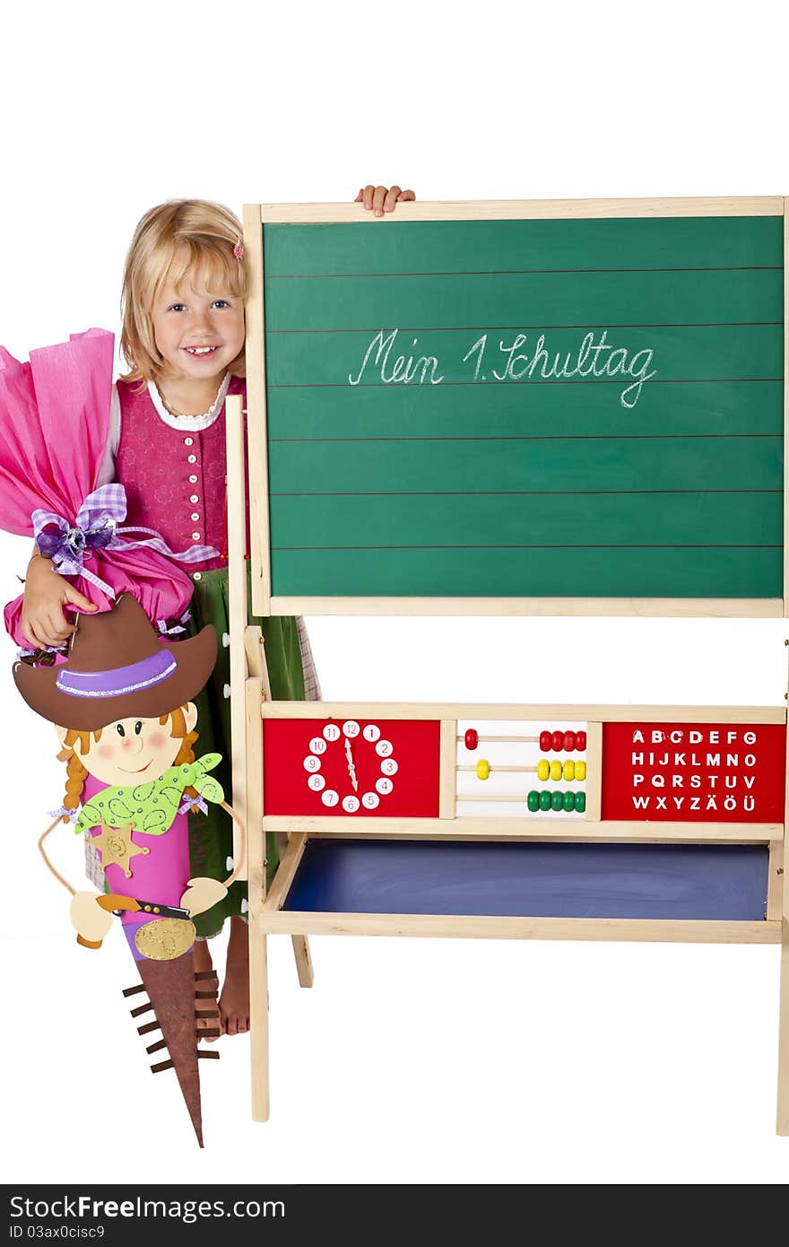 School girl stands happy beside chalk board