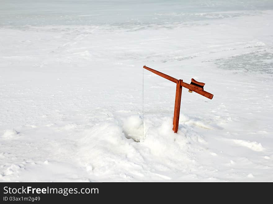 Classic ice fishing rod waiting for a bite. Classic ice fishing rod waiting for a bite