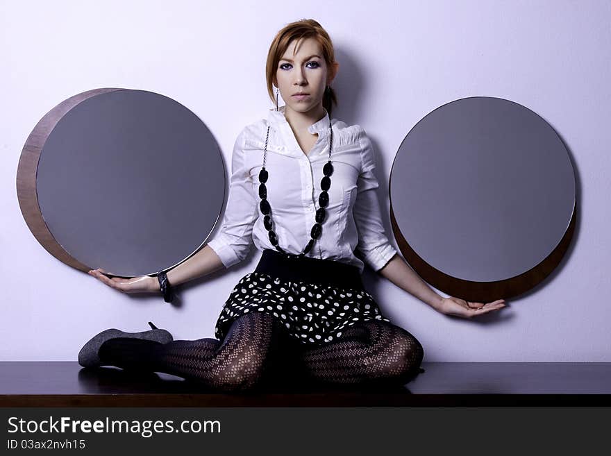 View of a beautiful woman making a sensual pose on the furniture. View of a beautiful woman making a sensual pose on the furniture.