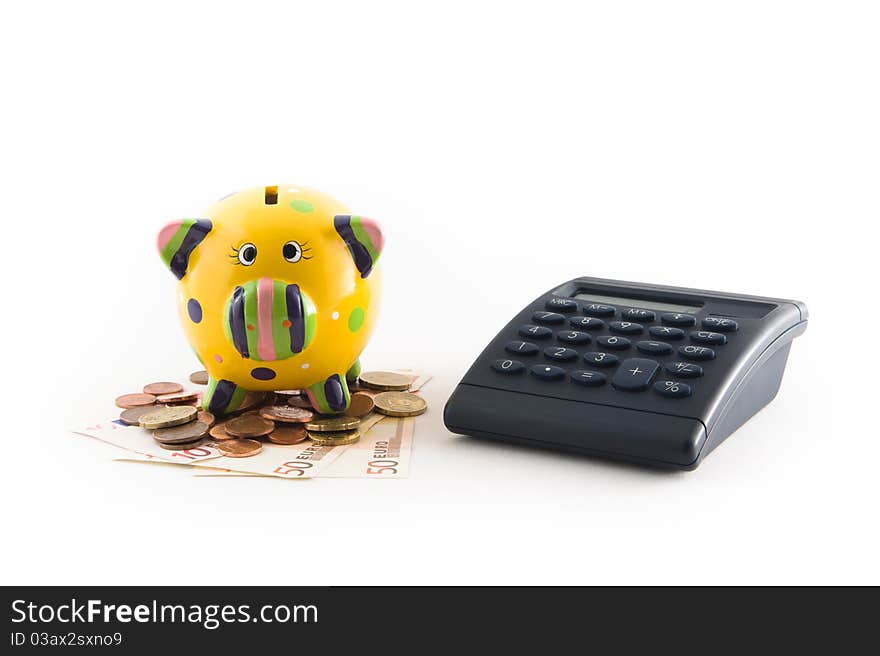 A piggy bank with money and a calculator on white background. A piggy bank with money and a calculator on white background