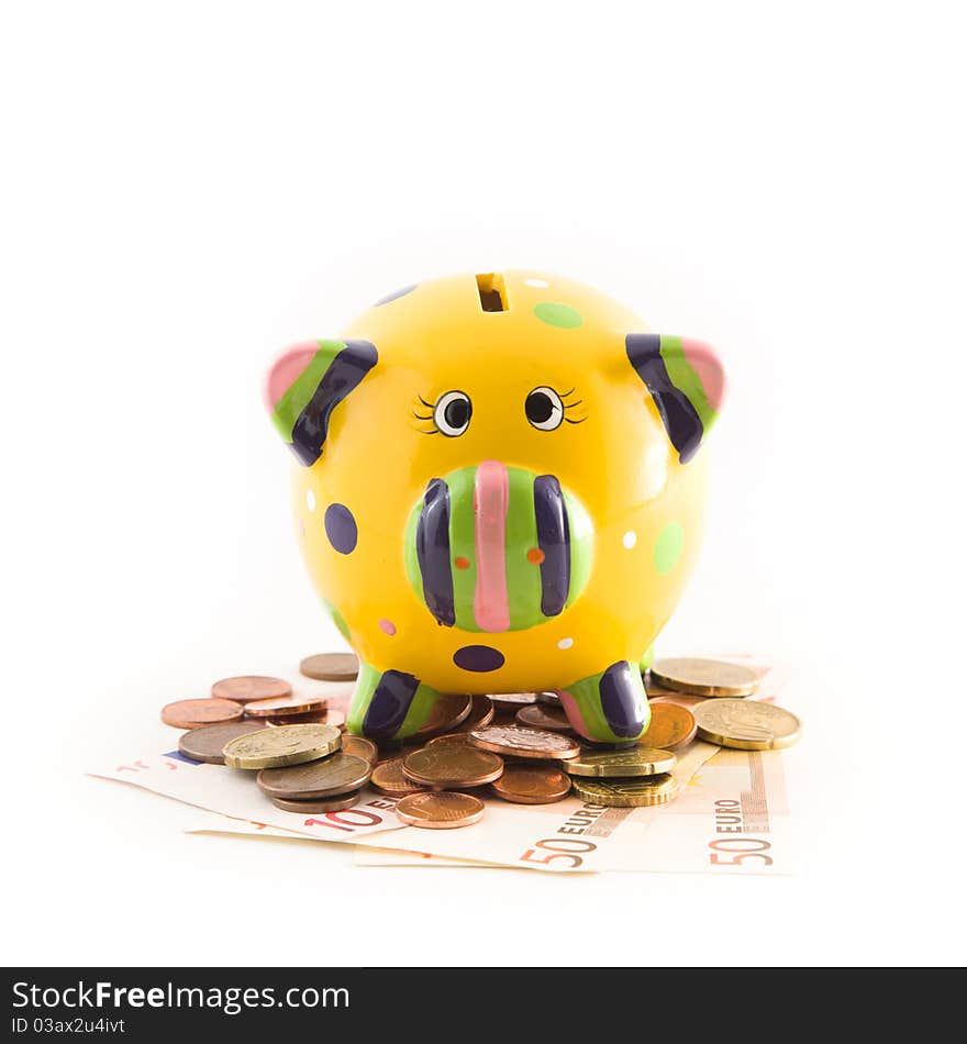 A piggy bank standing on money on white background. A piggy bank standing on money on white background