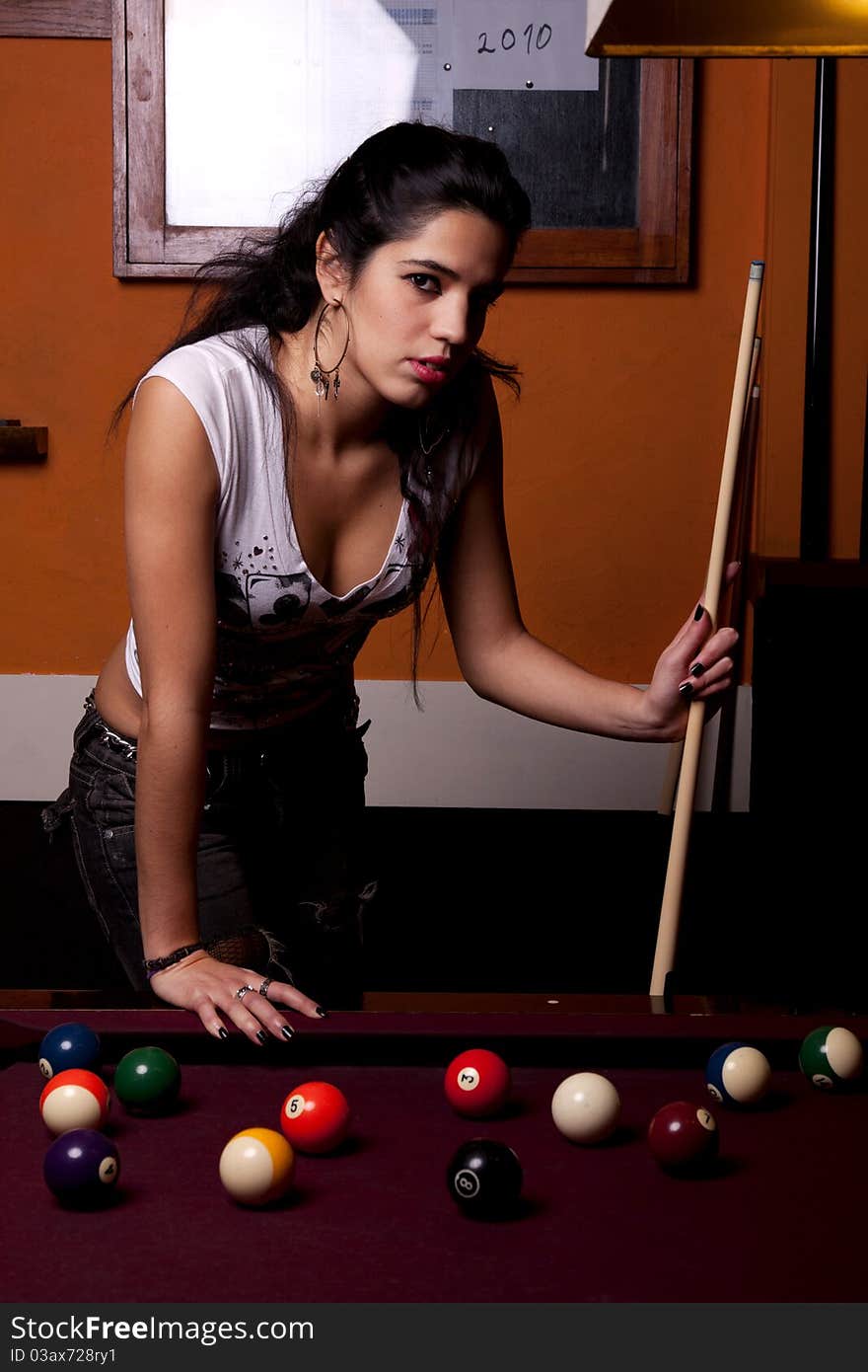 Detail view of a girl next to a snooker table. Detail view of a girl next to a snooker table.