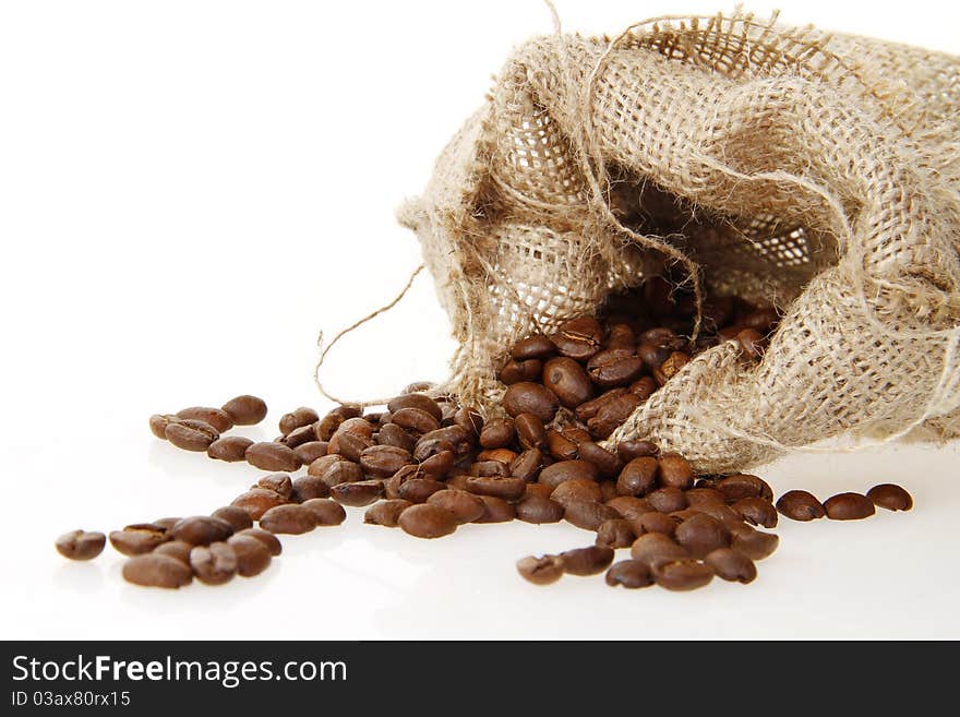 Burlap sack of roasted beans on the white background