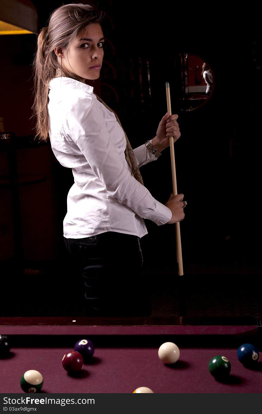 Detail view of a girl next to a snooker table. Detail view of a girl next to a snooker table.