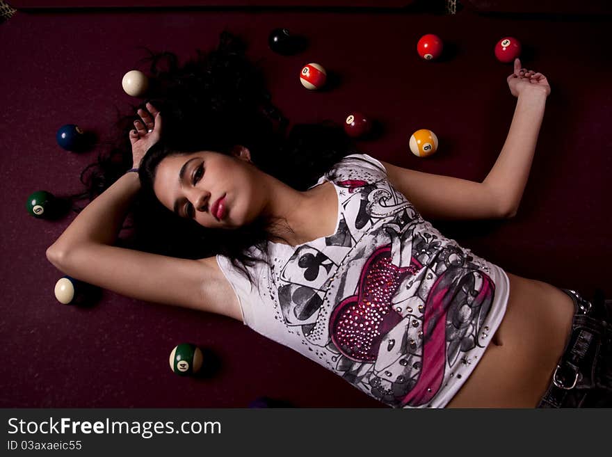 Detail view of a girl next to a snooker table. Detail view of a girl next to a snooker table.