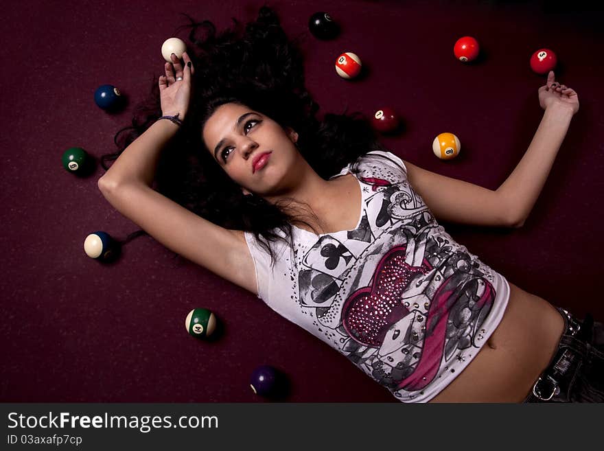 Detail view of a girl next to a snooker table. Detail view of a girl next to a snooker table.