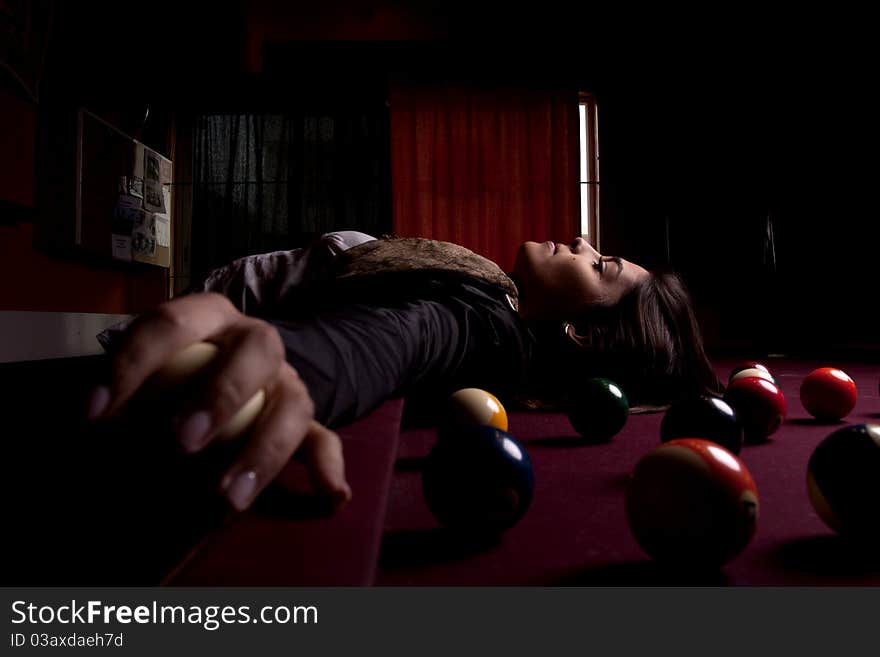 Detail view of a girl next to a snooker table. Detail view of a girl next to a snooker table.