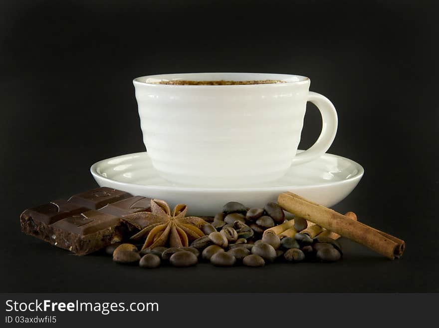 Cup of coffee and spice on black background. Cup of coffee and spice on black background.