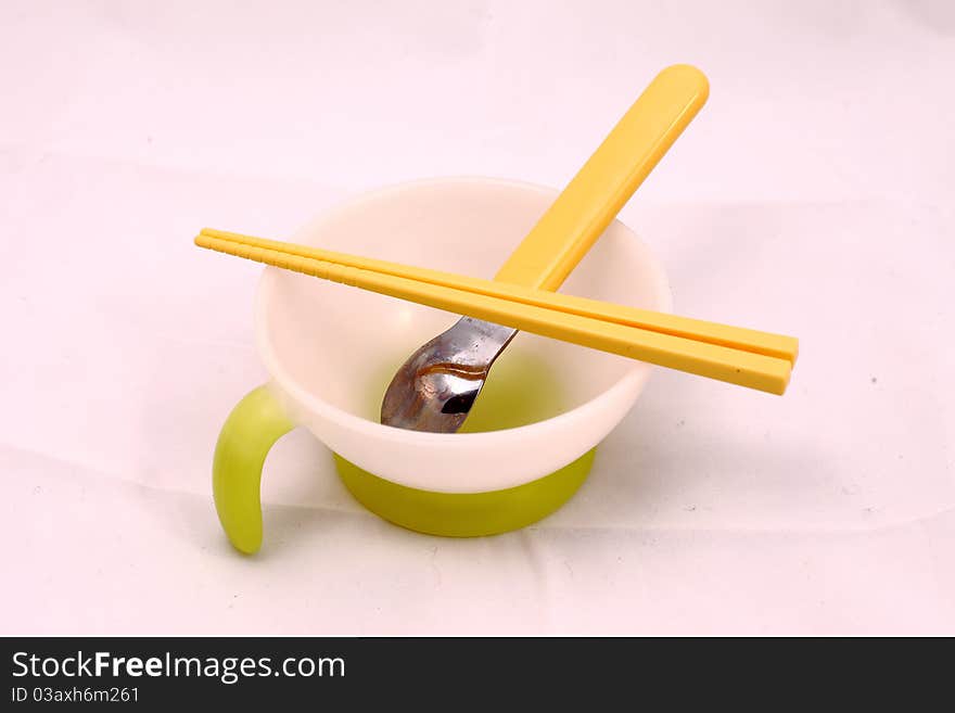 A set of child's tableware with bowl spoon and chopstricks.