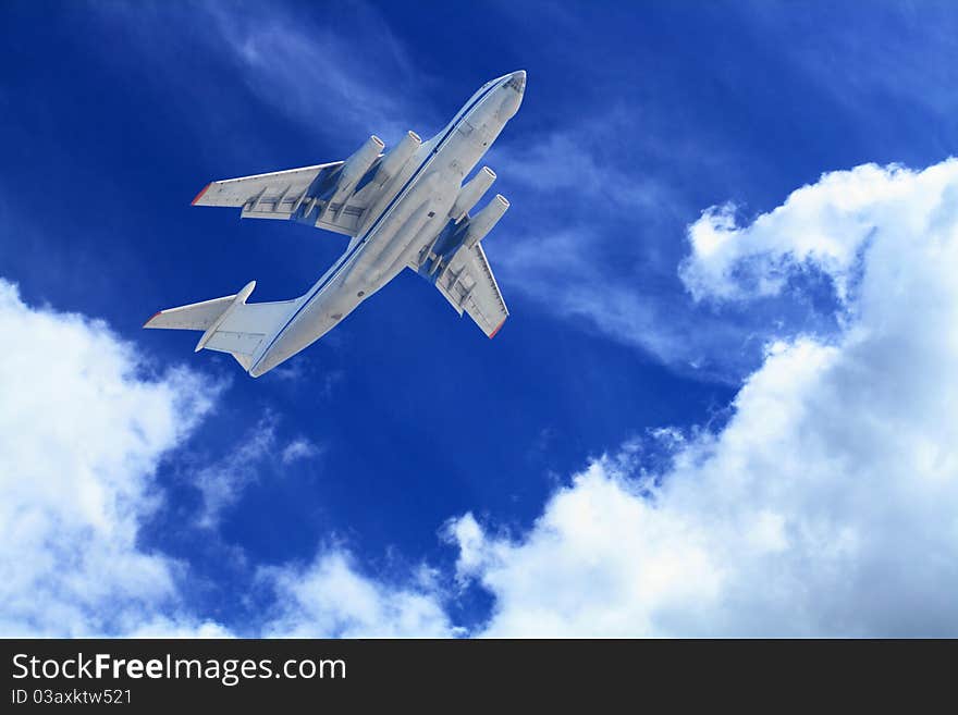 Passenger airplane flying in blue sky with clouds