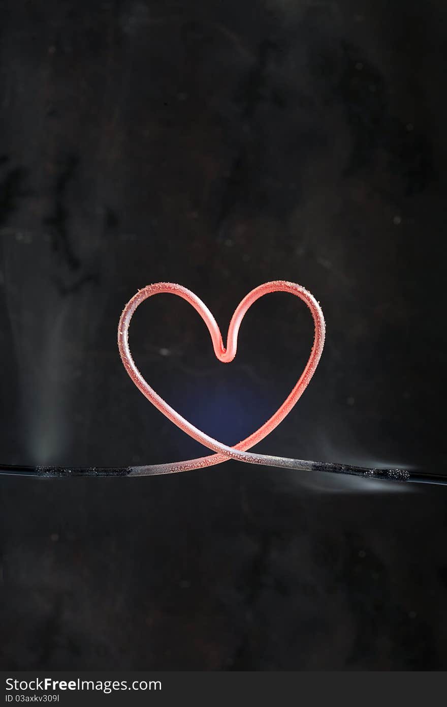 Hot heart made from metal wire isolated on dark background