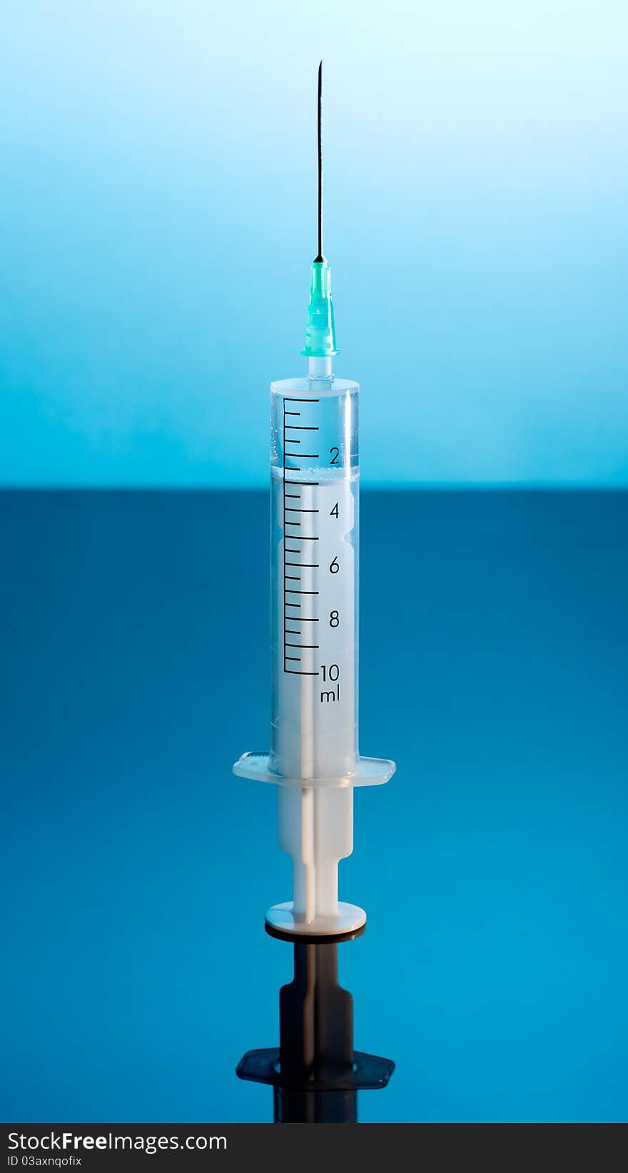 Medical Syringe on dark blue background.