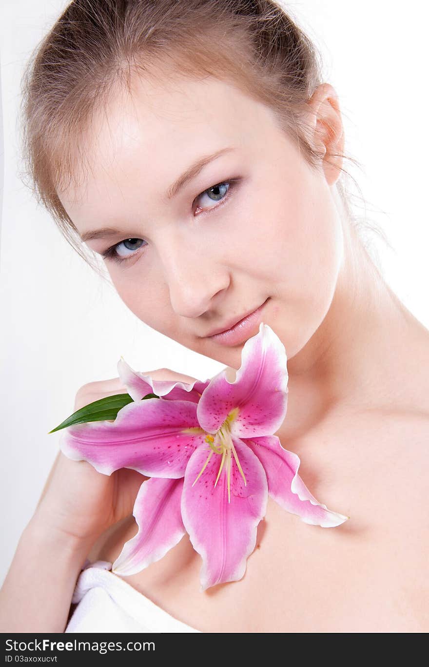 Close-up studio portrait of beautiful young woman with lily flower. Close-up studio portrait of beautiful young woman with lily flower