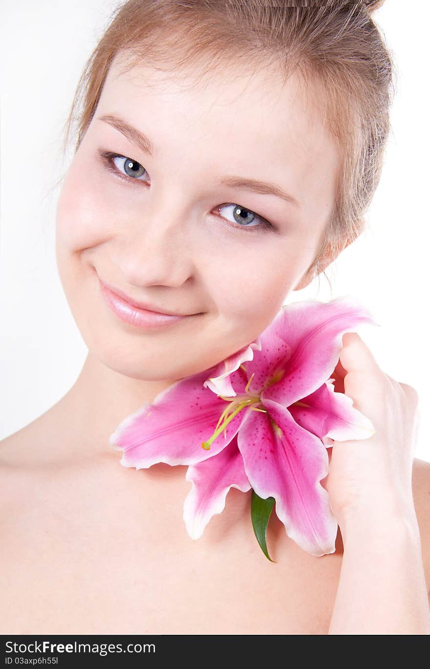 Close-up studio portrait of beautiful young woman with lily flower. Close-up studio portrait of beautiful young woman with lily flower