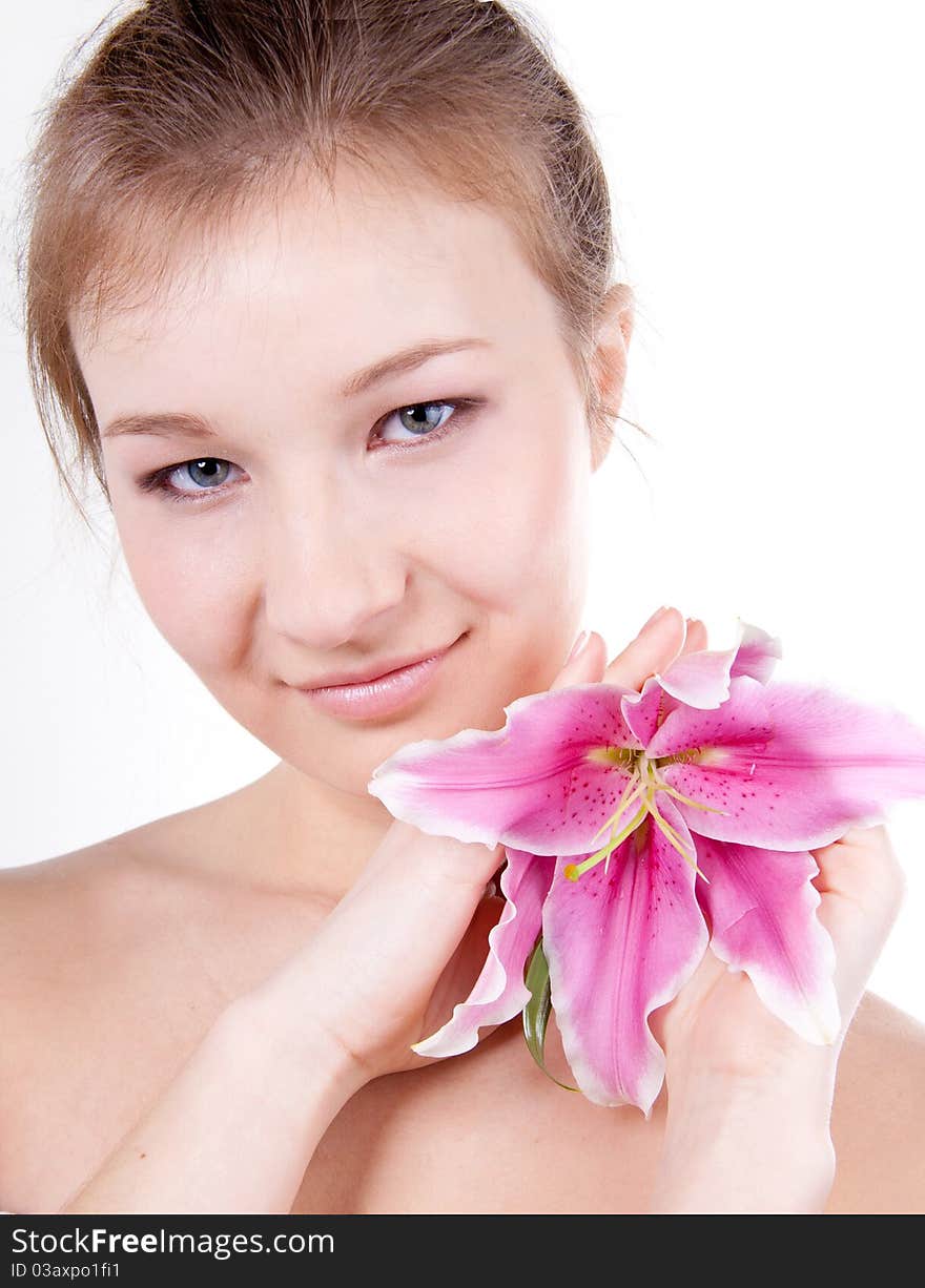 Close-up studio portrait of beautiful young woman with lily flower. Close-up studio portrait of beautiful young woman with lily flower