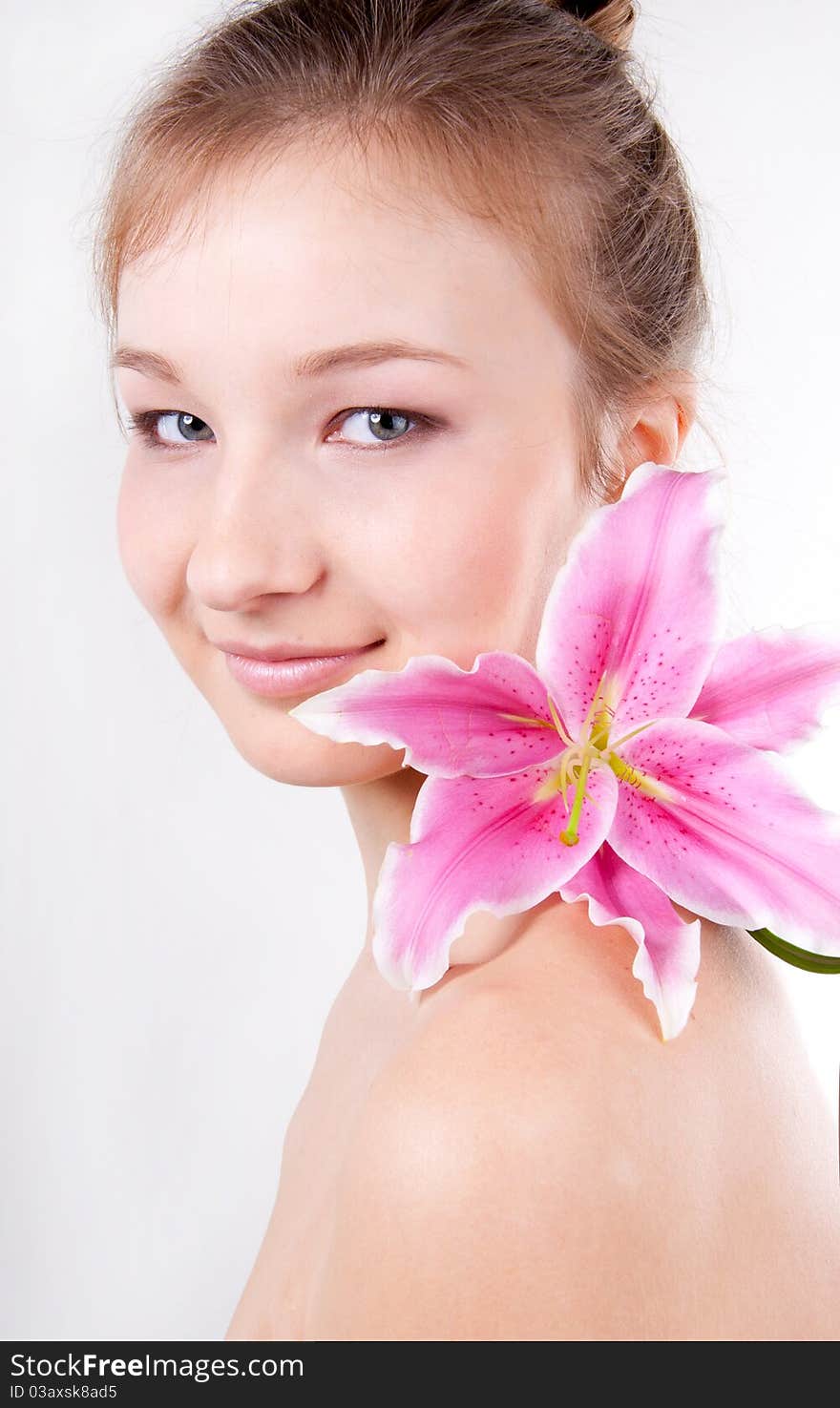 Close-up of  teenage girl with lily flower