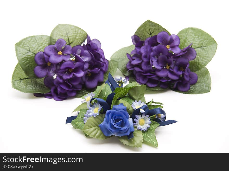 Artificial bunches of flowers onto white background