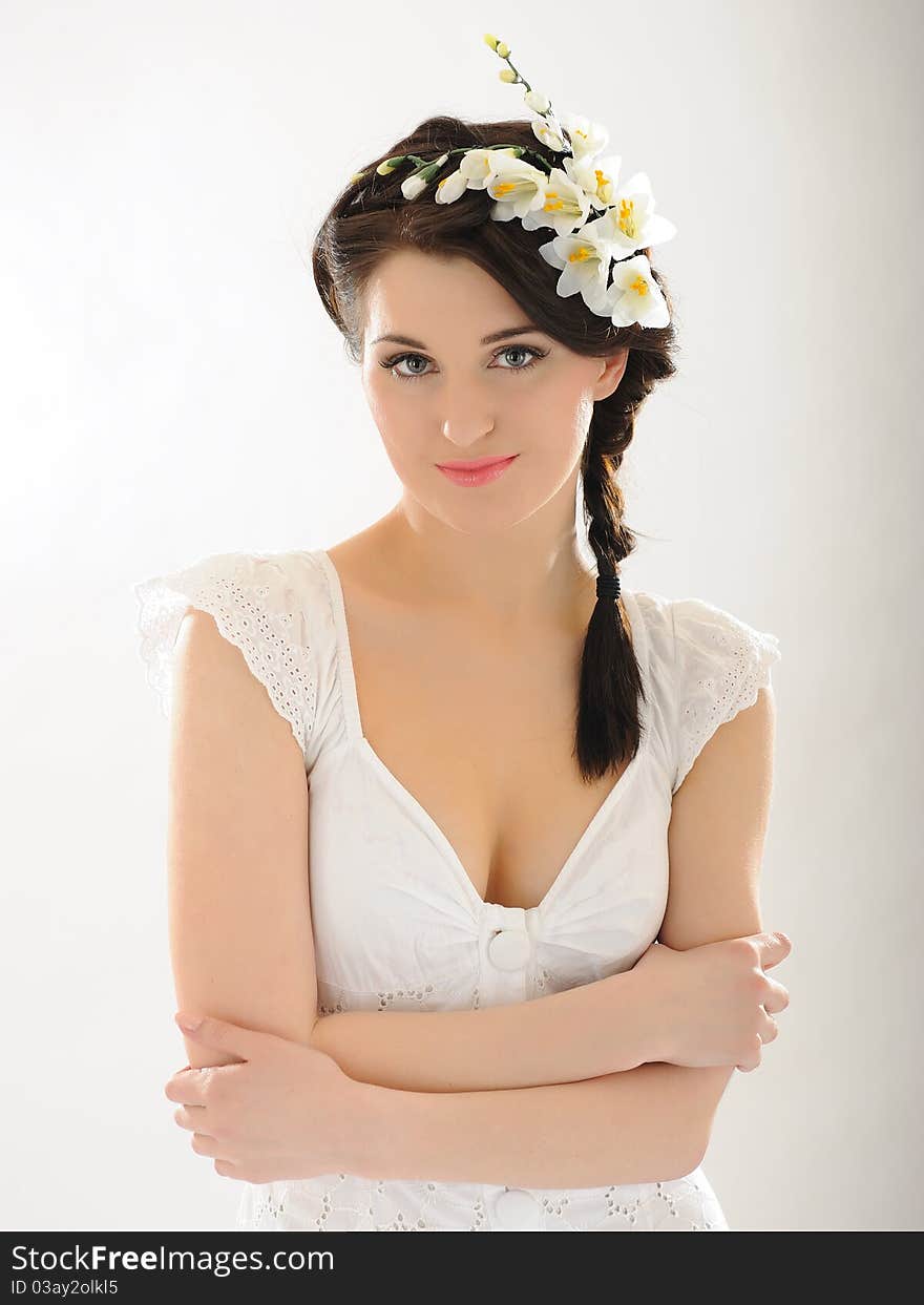 Beautiful fresh spring woman with flowers in her hair