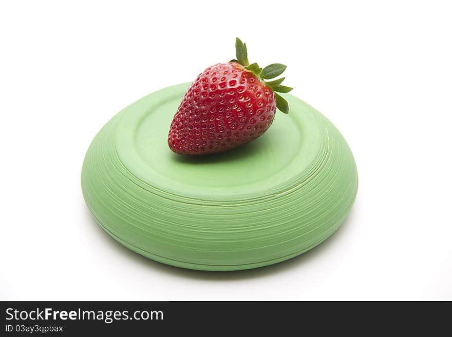 Strawberry onto green ceramic plate