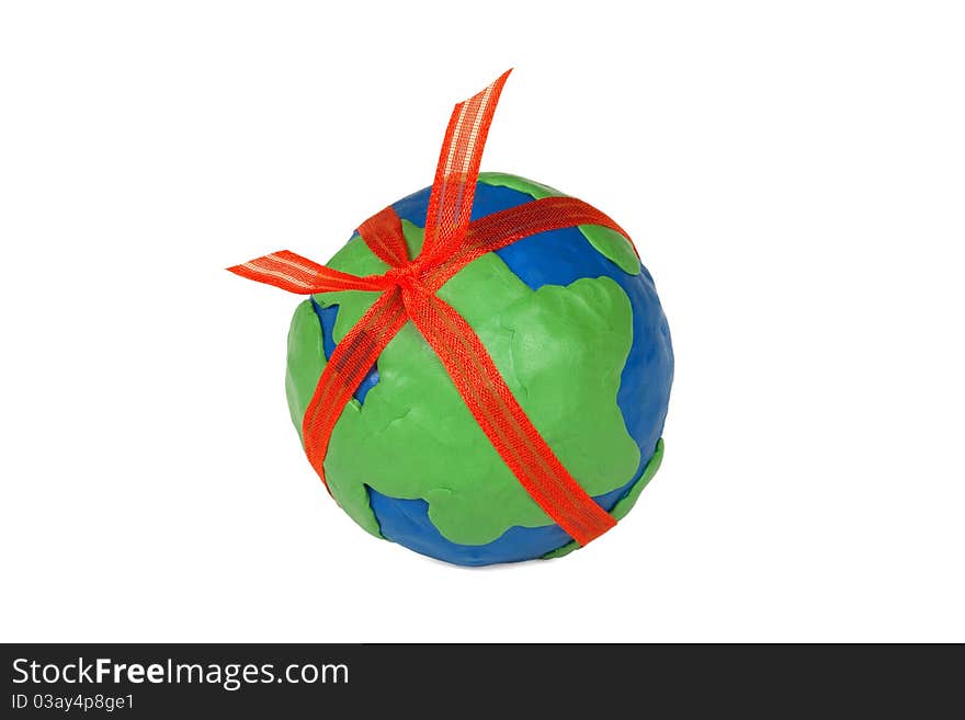 Plasticine globe with a red bow on white background. Plasticine globe with a red bow on white background