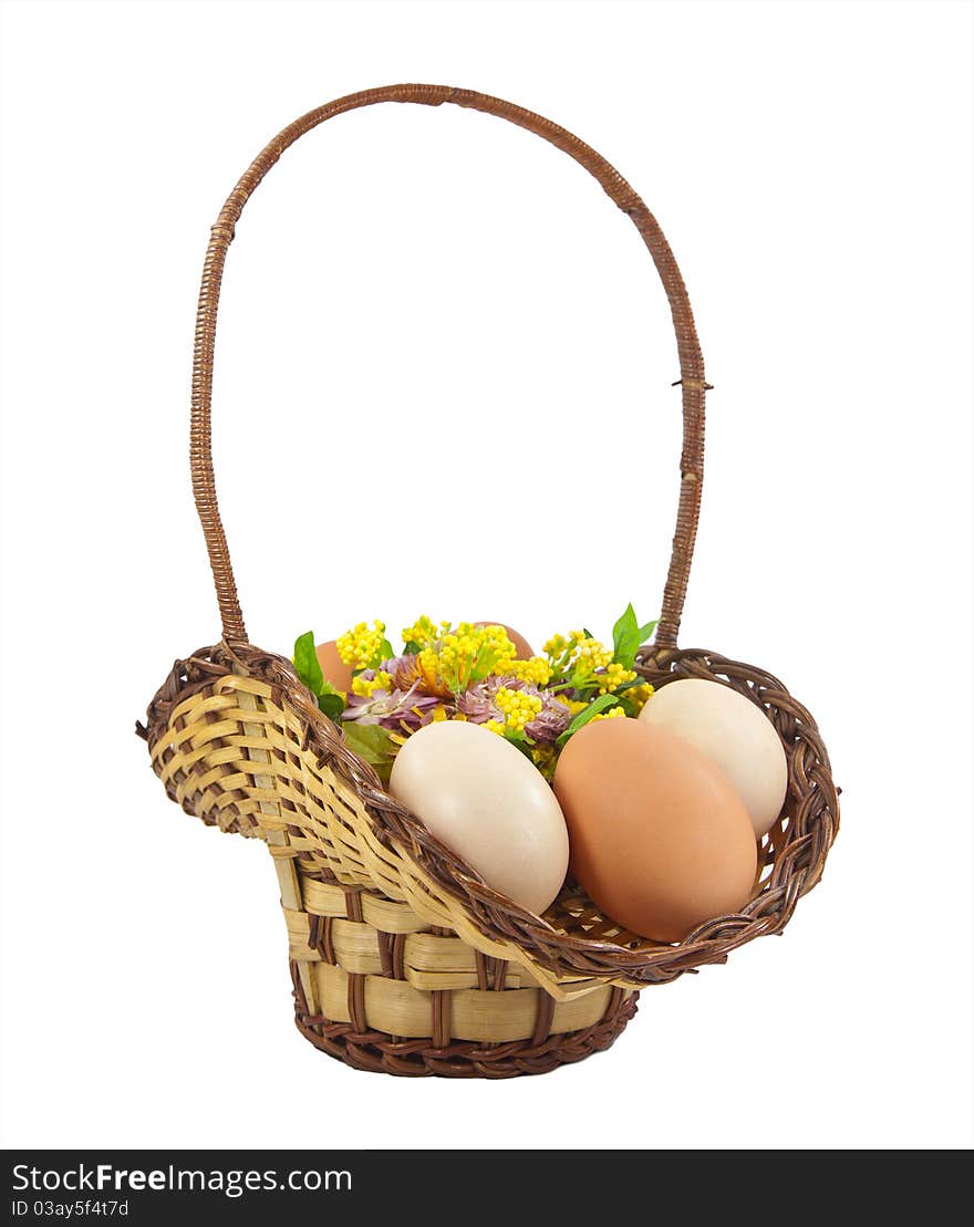 Easter eggs in brown basket on a white background