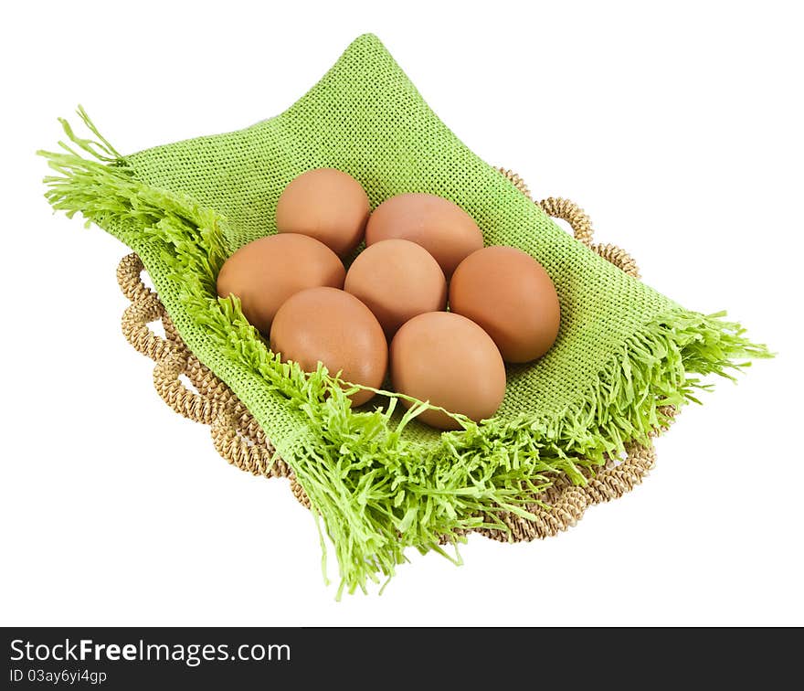 Easter eggs in brown basket on a white background