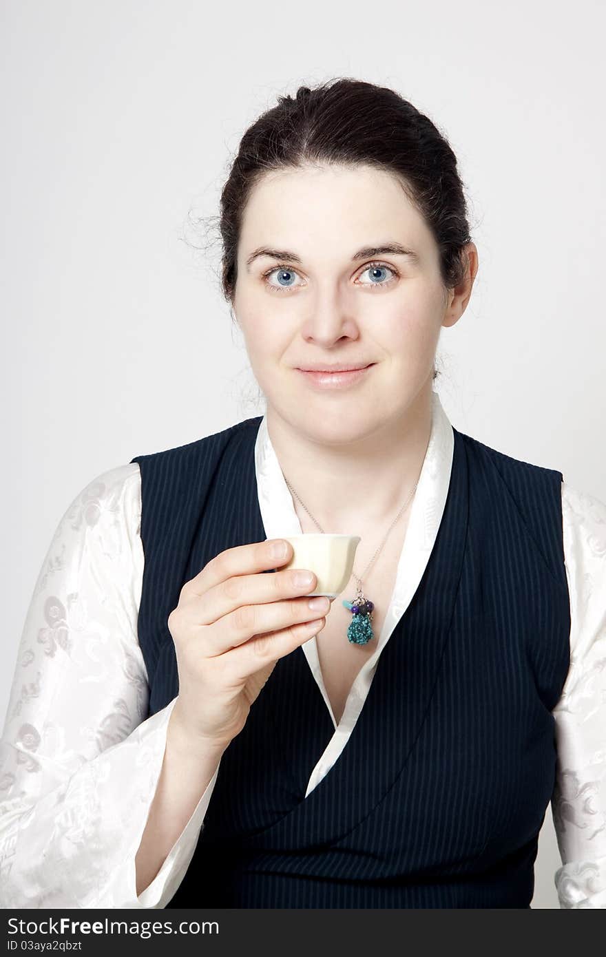 Portrait of woman in traditional tibetan dress with cup of tee