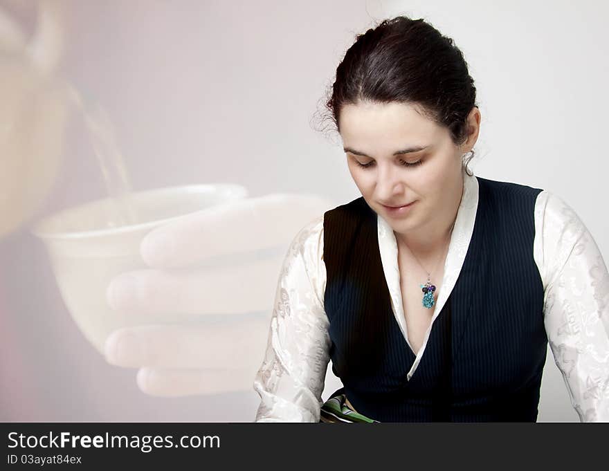 Woman in traditional tibetan dress with cup of tee