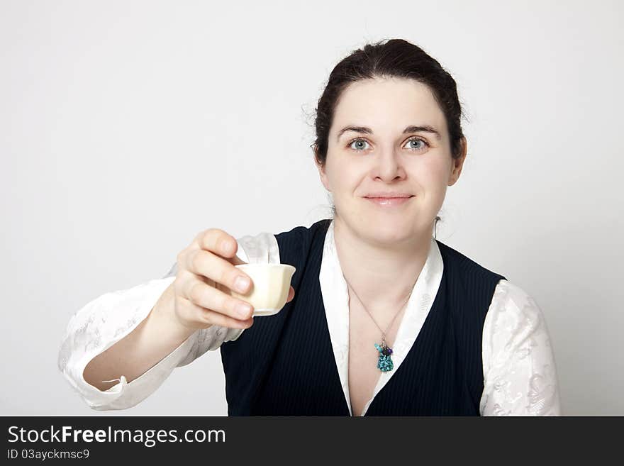 Woman in traditional tibetan dress with cup of tee