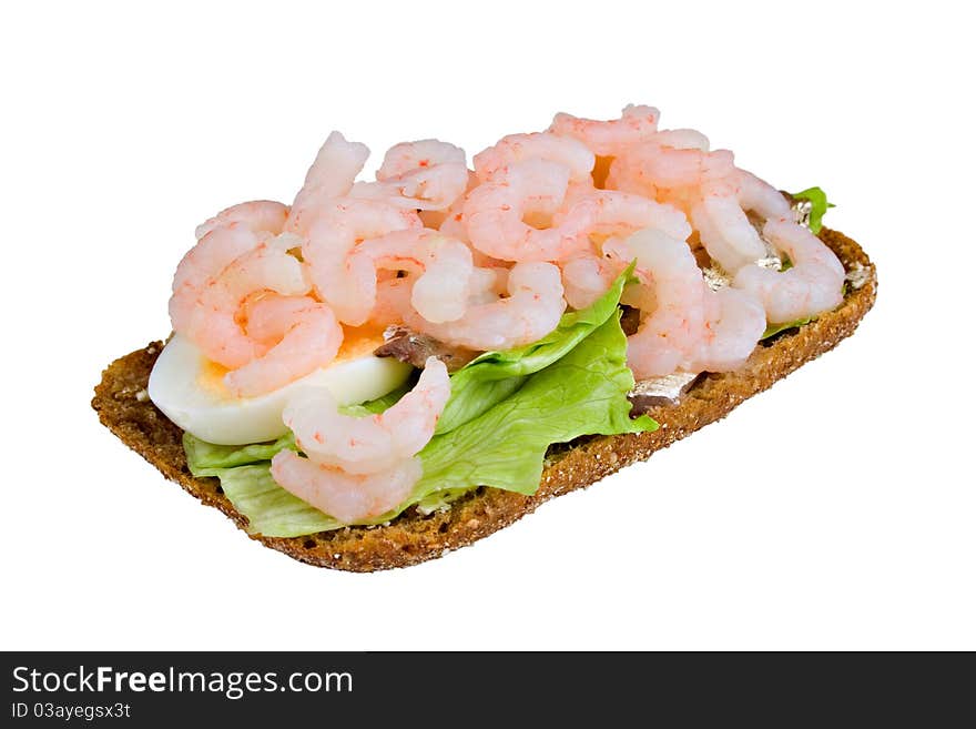 Open sandwich from rye bread, with salad, shrimps and anchovy.  Isolated white background. Open sandwich from rye bread, with salad, shrimps and anchovy.  Isolated white background.