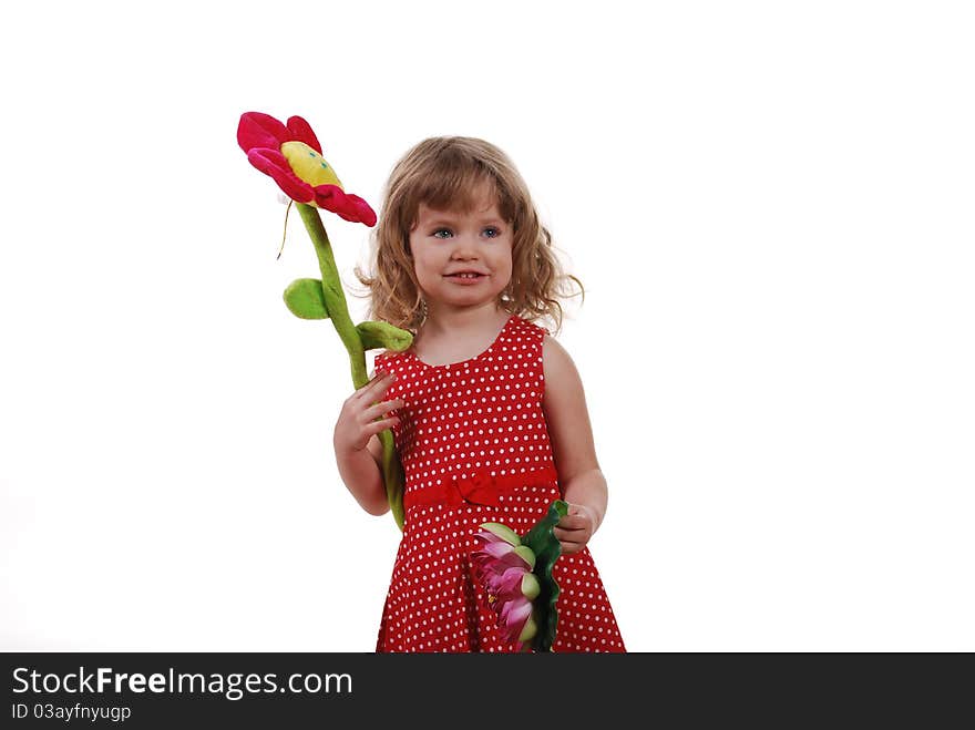 The girl in red dress holding a large toy flower. The girl in red dress holding a large toy flower