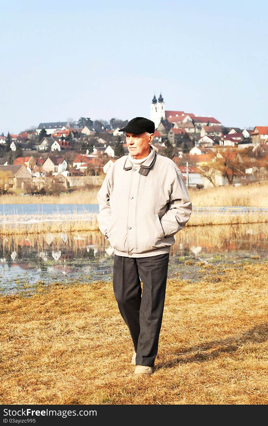 Senior man is walking at Central-Lake in Tihany, Hungary