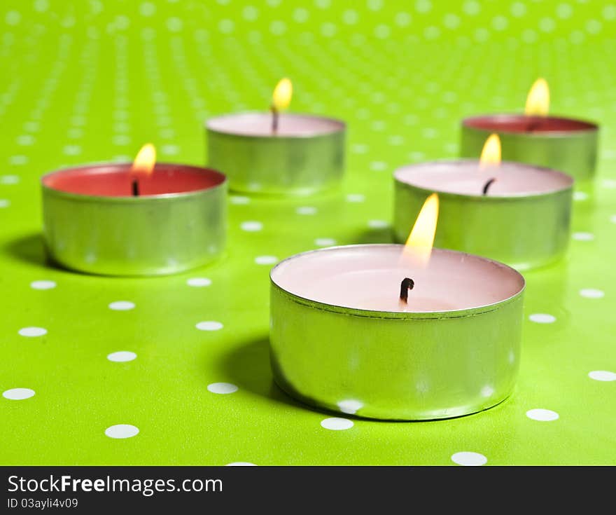 Candles isolated on green background