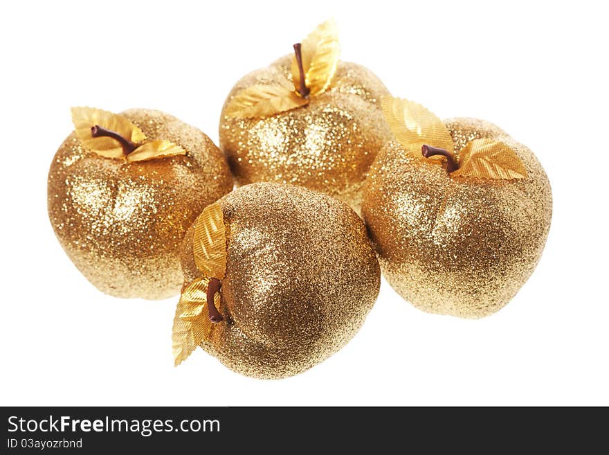 Golden apple lying on a white background