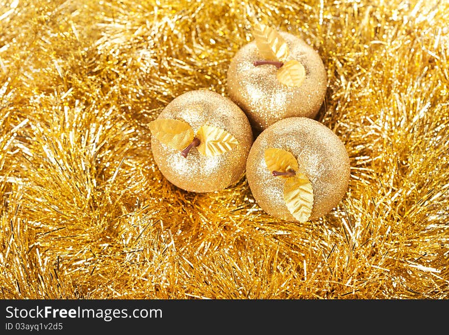 Golden apple lying on the golden background. Golden apple lying on the golden background