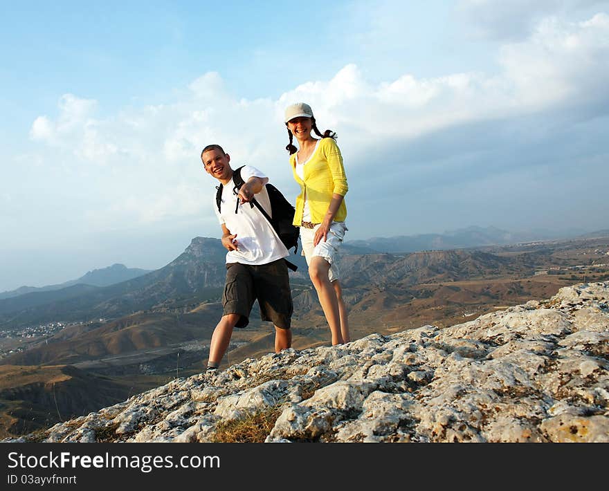 Happy guy and girl on the peak of a mountain. Happy guy and girl on the peak of a mountain