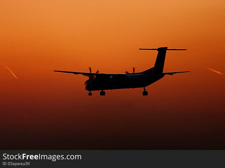 Turboprop plane landing in sunset. Turboprop plane landing in sunset