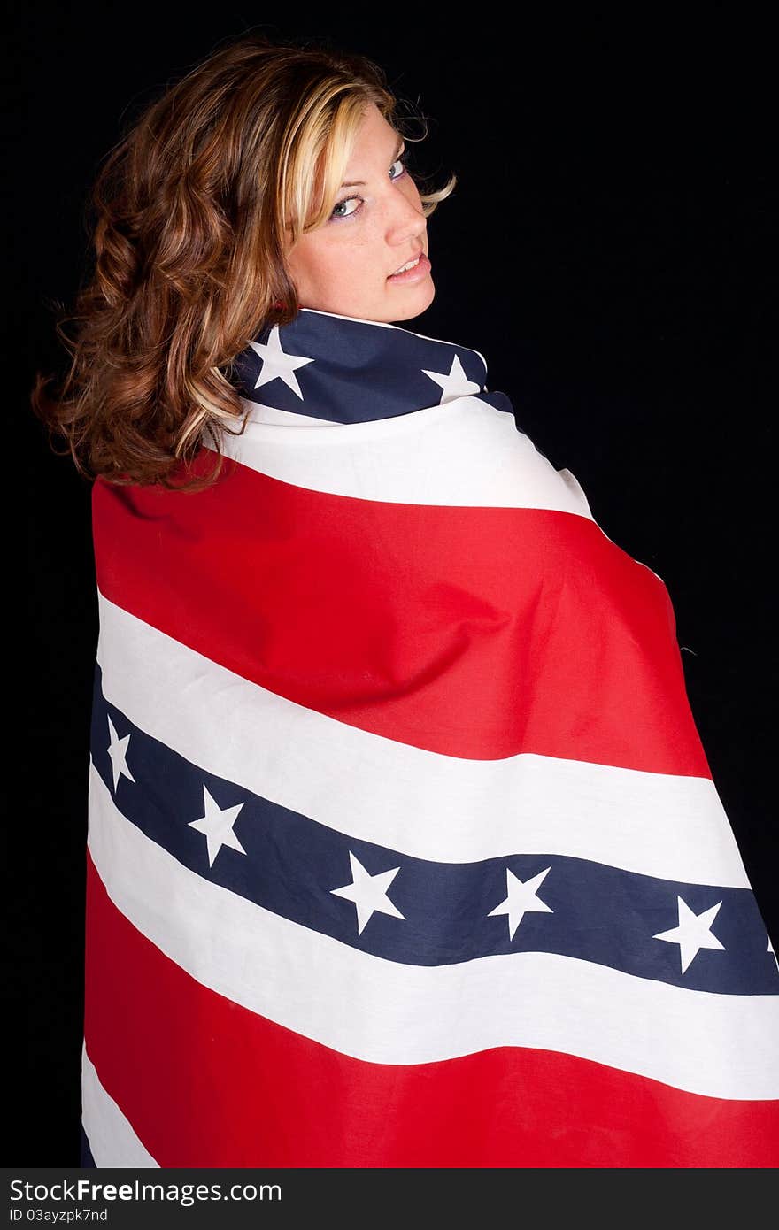 A peaceful young woman wrapped in a patriotic design. A peaceful young woman wrapped in a patriotic design.