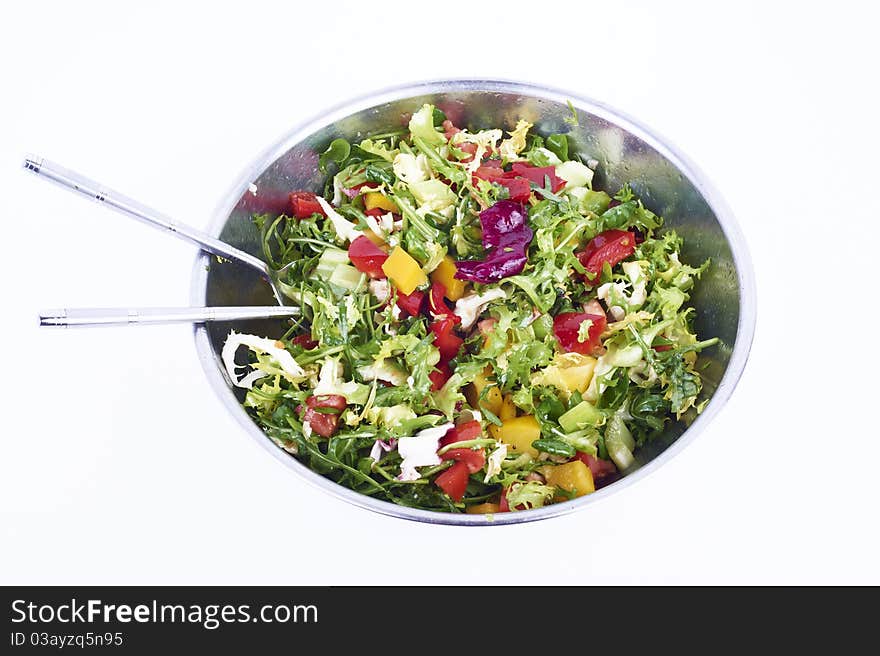 Salad with fresh lettuce leaves, tomatoes, red and yellow pepper, cucumber in a bowl isolated on white background. Salad with fresh lettuce leaves, tomatoes, red and yellow pepper, cucumber in a bowl isolated on white background