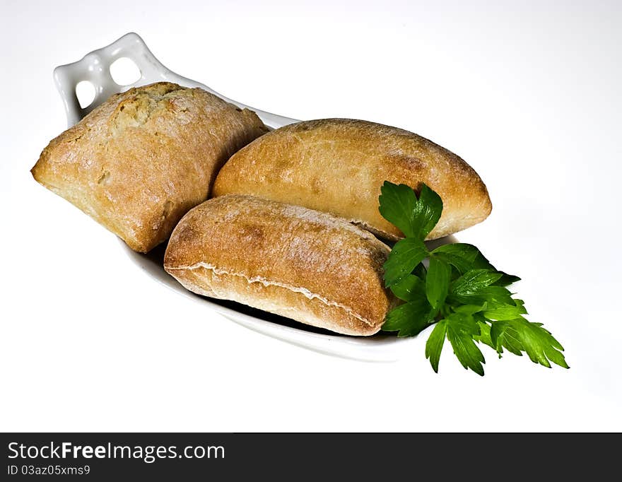 Ciabatta bread rolls on porcelain dish