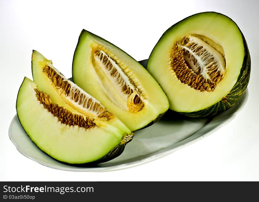 Green melon on porcelain dish