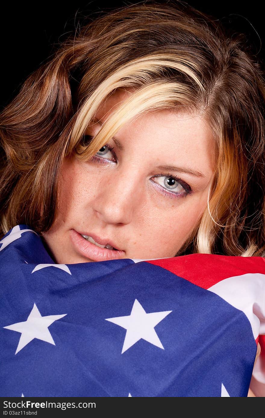 A girl holding the American flag near and dear to her. A girl holding the American flag near and dear to her.