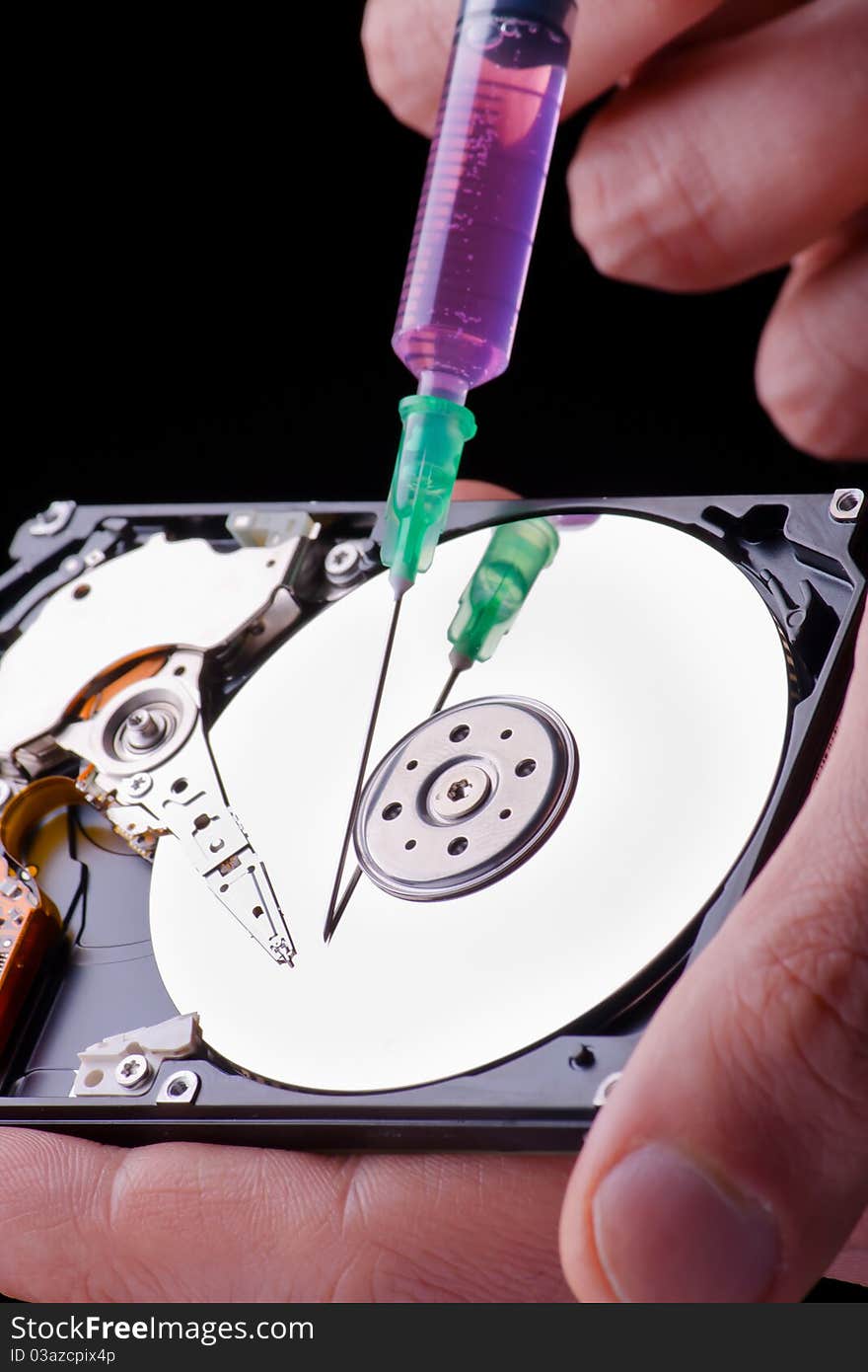 Conceptual photo of repairing hard disc with surgical needle. Conceptual photo of repairing hard disc with surgical needle.