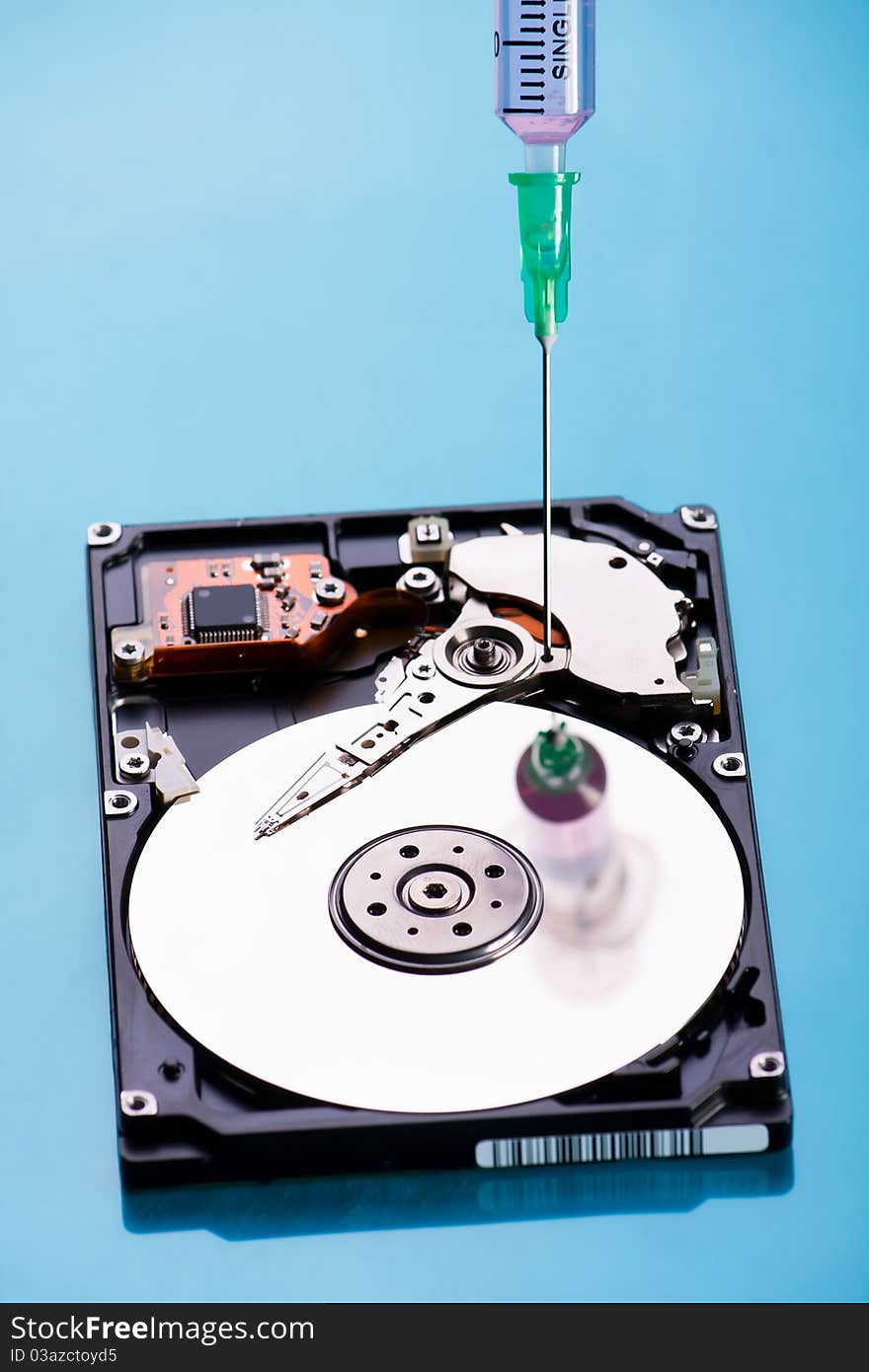 Conceptual photo of repairing hard disc with surgical needle. Conceptual photo of repairing hard disc with surgical needle.